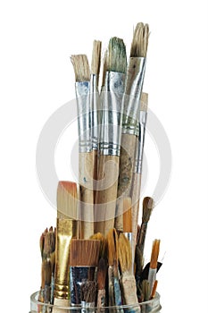 Various professional paint brushes in the jar on white background
