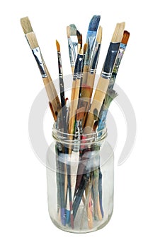 Various professional paint brushes in the transparent jar