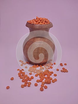 Various pulses in traditional wooden jars, red lentils. isolated in white background