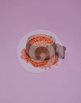 Various pulses in traditional wooden pots, red lentils. isolated in white background