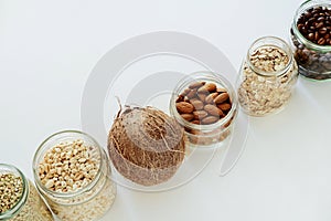 Various raw cereals, grains in glass jars.