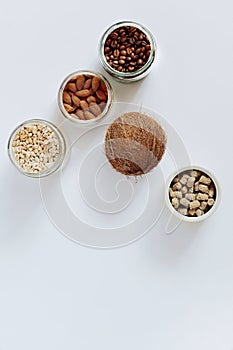 Various raw cereals, grains in glass jars.