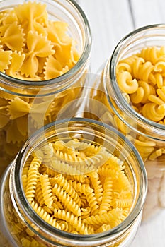 Various raw pasta in glass jar