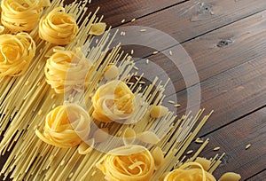 Various raw pasta on a wooden table. Food background concept. Italian food and menu concept