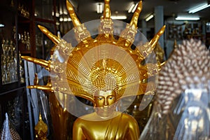 Various religious golden figurines in a souvenir shop