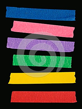 Various ripped pieces of multi color masking tape photo