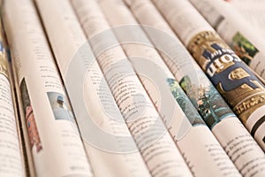 Various rolled newspapers, closeup