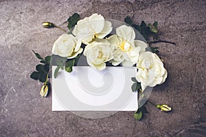 Various roses on dark marble background with empty card for greeting message. Mother`s Day and spring background concept. Holiday