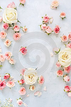 Various roses, petals and buds on textured background