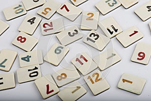 Various rummikub pieces on white background