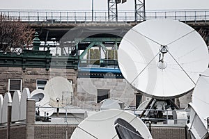 Various satellite dishes and emitters in the technical hub of a media television and radio broadcaster in the suburbs of Montreal,