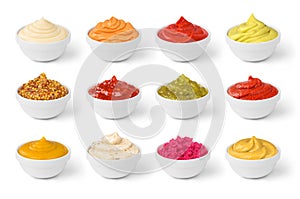 Various sauces set in the white bowls isolated photo