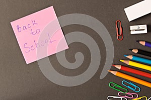 Various school supplies on the blackboard background . The concept of education. With empty space for text