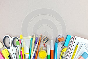 Various school supplies and office stationary on grey background