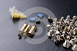 Various screws for assembling computer sets. Accessories for mechanic electronics