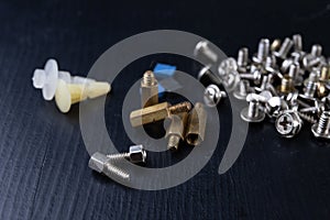 Various screws for assembling computer sets. Accessories for mechanic electronics