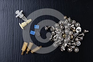 Various screws for assembling computer sets. Accessories for mechanic electronics