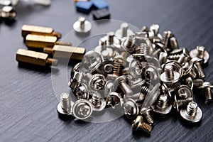 Various screws for assembling computer sets. Accessories for mechanic electronics