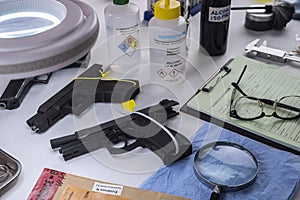 various sealed automatic pistols in crime lab, crime investigation