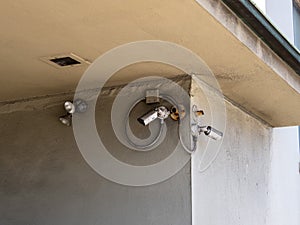 Various security cameras, lights and motion detectors outside building