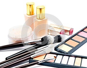 Various set of professional makeup brushes and cosmetics and palette of colourful eye shadows isolated