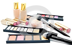 Various set of professional makeup brushes and cosmetics and palette of colourful eye shadows isolated