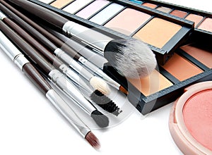 Various set of professional makeup brushes and palette of colourful eye shadows isolated