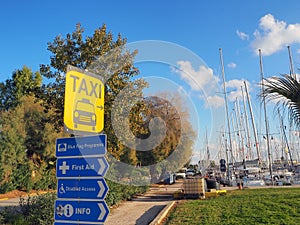 Various signs on the street in yellow, black, white and blue