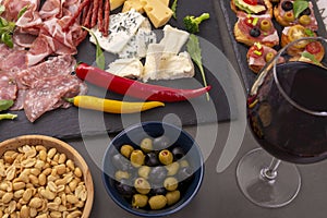 Various snacks on table with wine