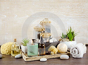 Various spa bath room beauty products on wooden tray  bath bomb  aroma massage oils.