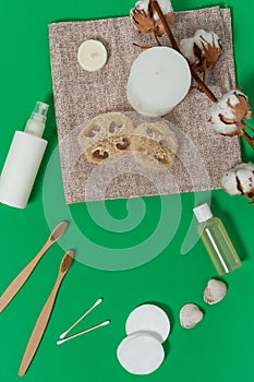 Various spa and beauty threatment products isolated on green background. natural concept photo