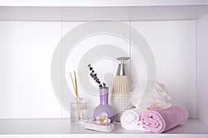 Various spa and beauty threatment products on white shelf photo