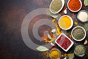 Various spices in a bowls on stone table. photo