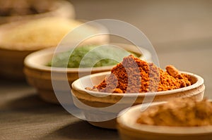Various spices in ceramic bowls with selective focus on dried chilly