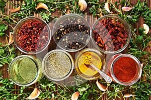 Various spices for dishes on wooden boards, camera from above