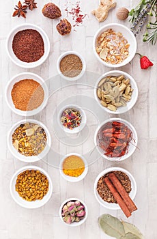 Various spices, dried and fresh herbs on table