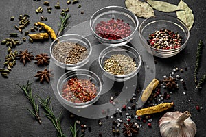 Various spices on a gray background. seasoning in glass cups side view