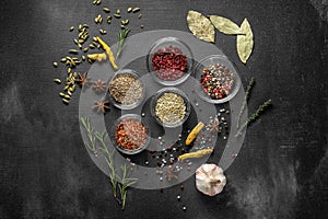 Various spices on a gray background. seasoning in glass cups top view