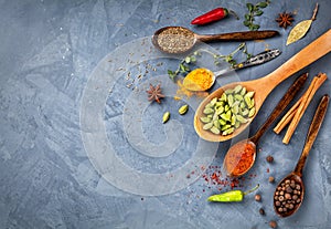 Various Spices near blackboard at blue stone background