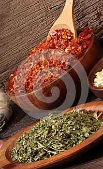 Various spices over a wood background. Different c