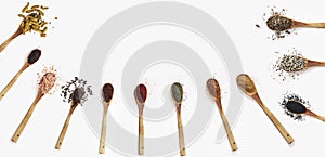 Various spices spoons on white table. Top view with copy space.