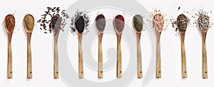 Various spices spoons on white table. Top view with copy space.