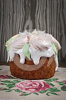 Various Spring Easter cakes with white icing and sugar decor on the table decorated in rustic style