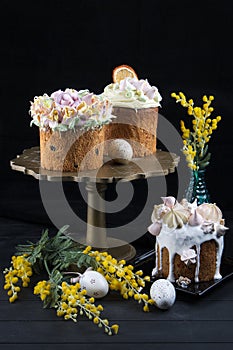 Various Spring Easter cakes with white icing and sugar decor on the table decorated in rustic style