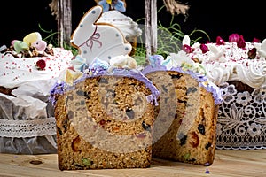 Various Spring Easter cakes with white icing and sugar decor on the table decorated in rustic style