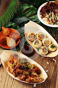 Various street food with pani puri, chicken wings and coxinha on