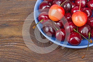 Various summer Fresh Cherry in a bowl on rustic wooden table. Antioxidants, detox diet, organic fruits. Berries