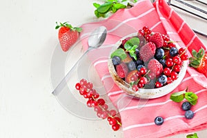 Various summer fruits in a bowl. Assorted fresh berries with lea