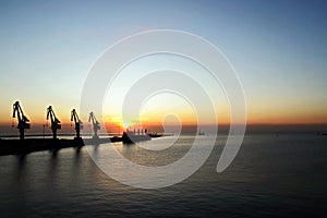 Various sunset views of the docks, piers, terminal of the Port of Huludao, China, November, 2020.