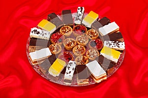 Various sweet cakes on round plate